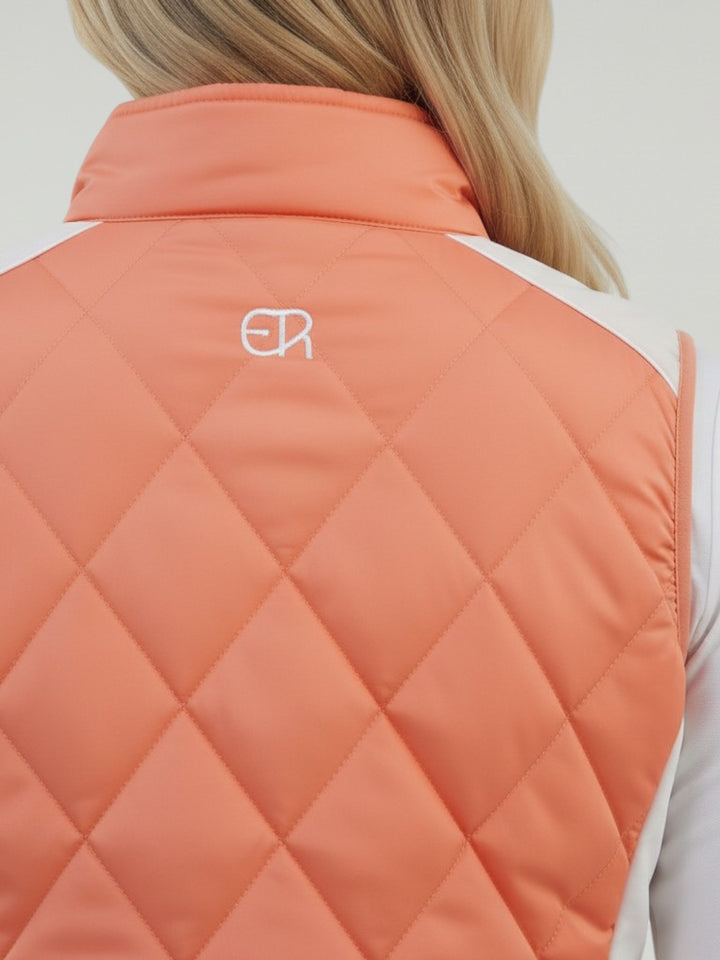 Elliott & Rose quilted tangerine golf vest with embroidered logo on back. 