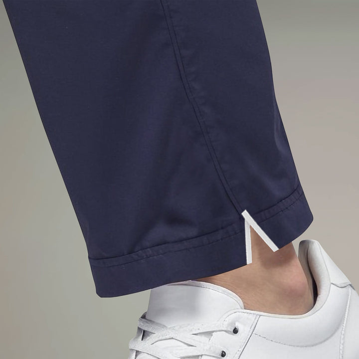 Elliott & Rose navy golf pants with four-way stretch, functional pockets, and white piping detail at the ankle.