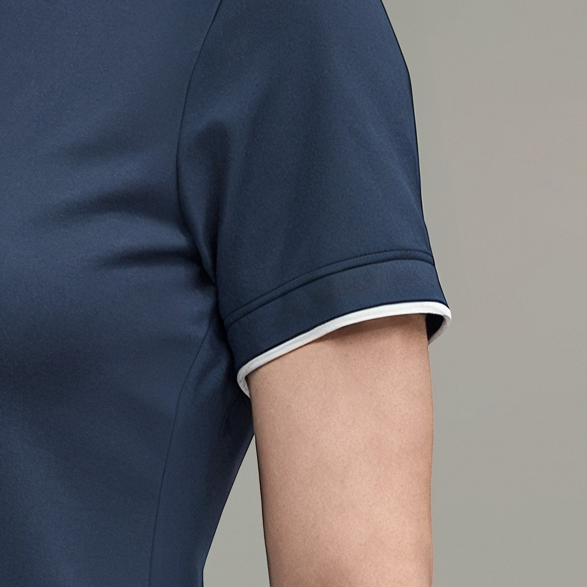 Elliott & Rose navy blue performance golf polo shirt with white trim on sleeves. Moisture-wicking fabric.