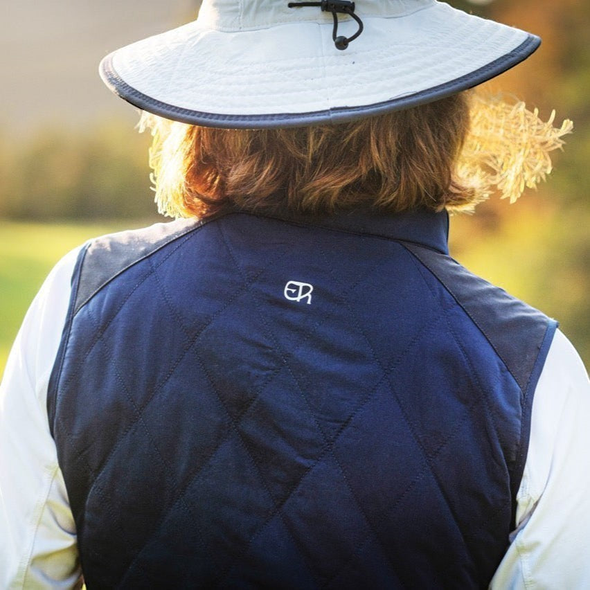 Elliott & Rose navy quilted golf vest with diamond pattern and side panels for movement. Lightweight and insulated.