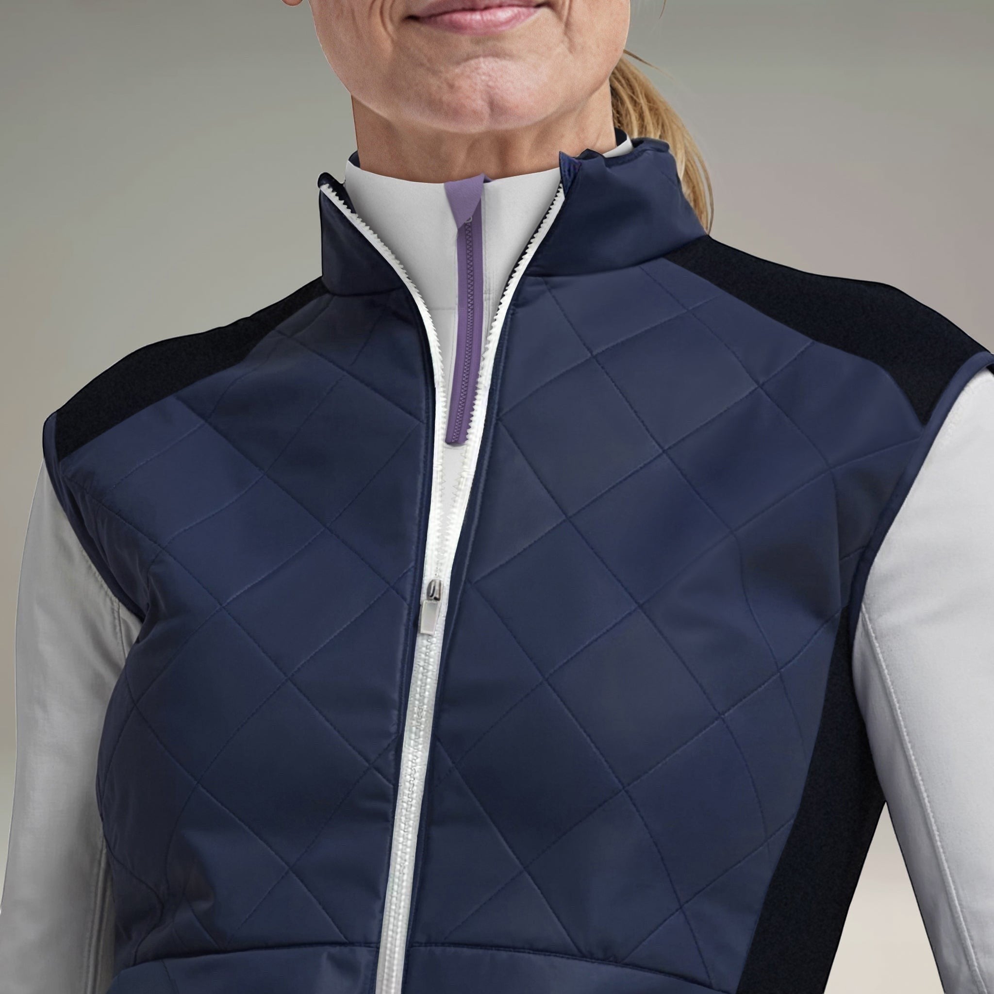 Elliott & Rose navy quilted golf vest with black side panels and a white full-zip front.