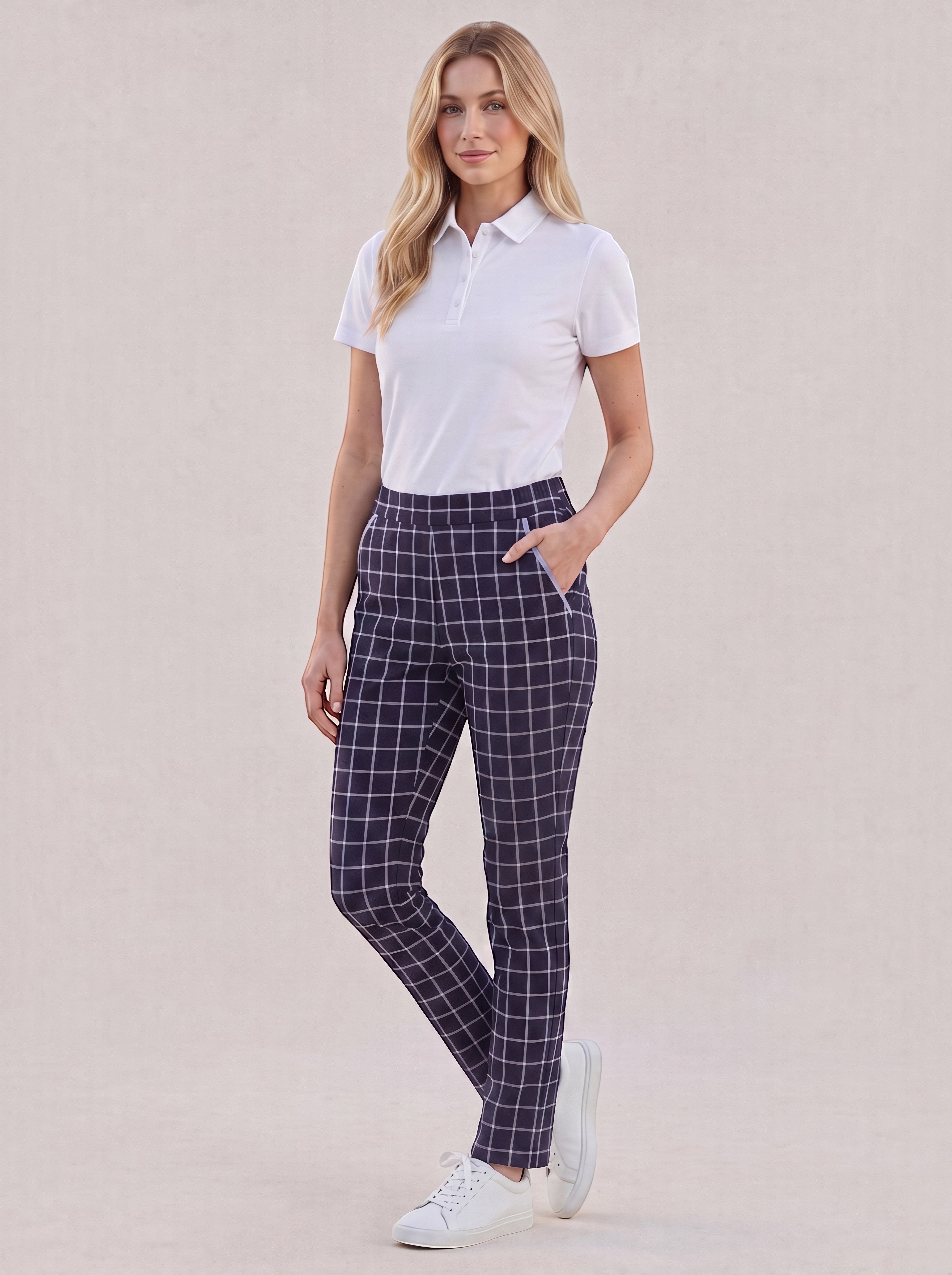 Elliott & Rose navy windowpane golf pants with lilac piping worn by a blonde model in a white polo and sneakers.