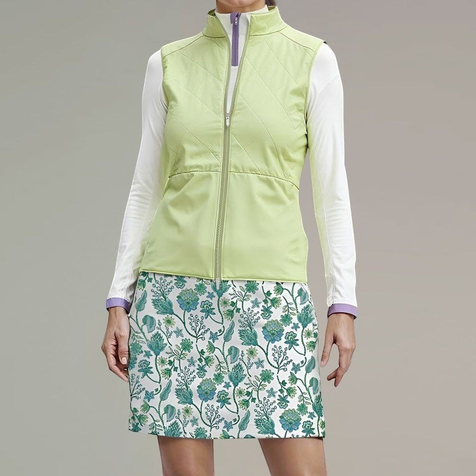 Elliott & Rose quilted chartreuse golf vest with full-zip front and stand-up collar, layered over a white long-sleeve shirt.