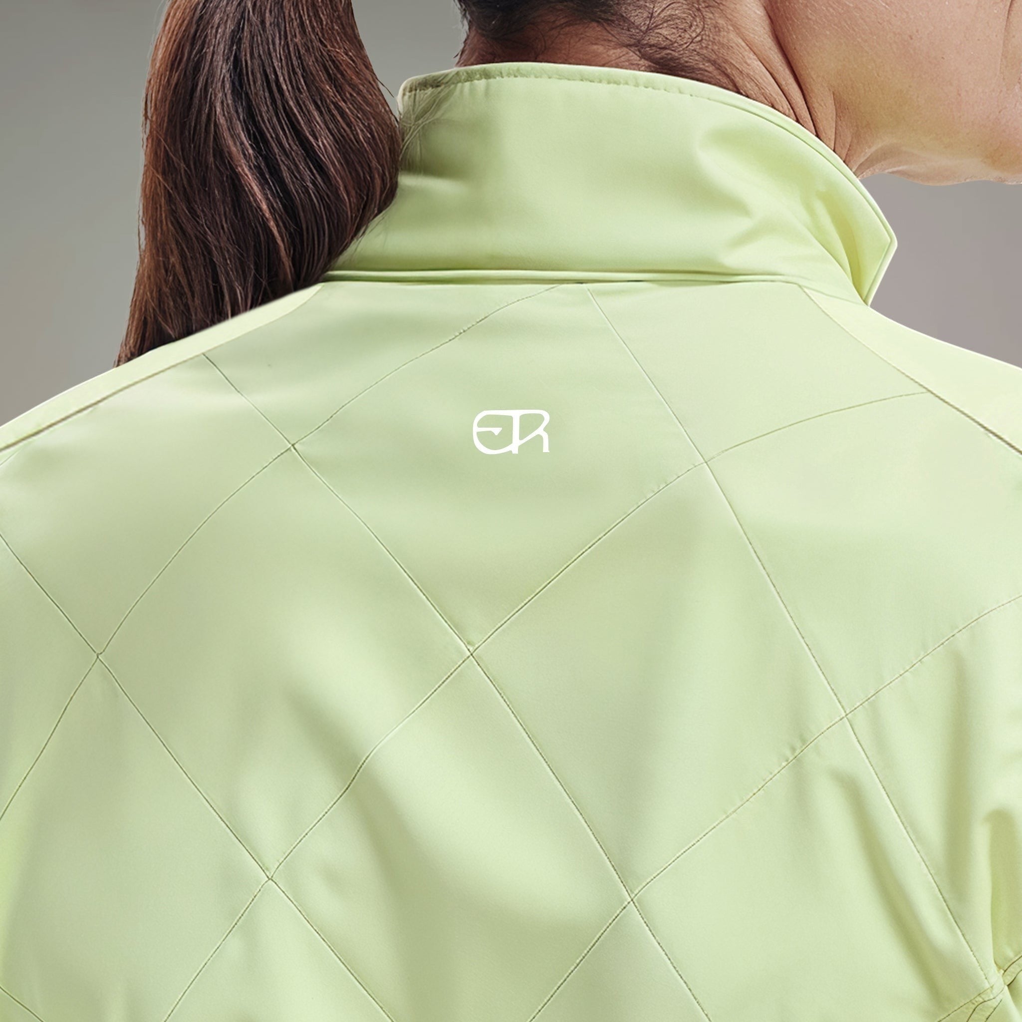 Elliott & Rose quilted chartreuse golf vest with stand-up collar and ER logo.
