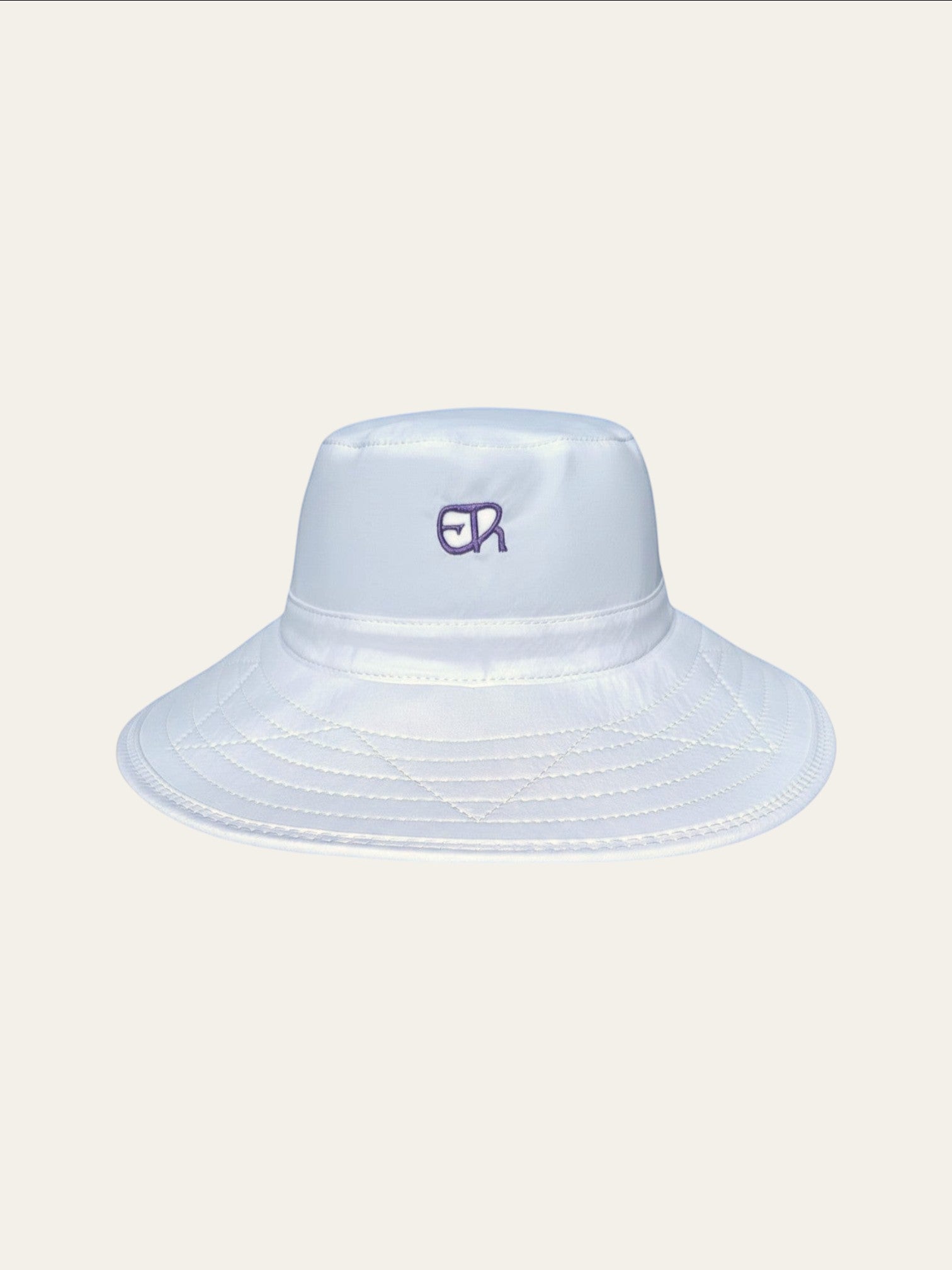 Elliott & Rose white nylon bucket hat with lilac ER logo and quilted brim. UPF 50+ protection.