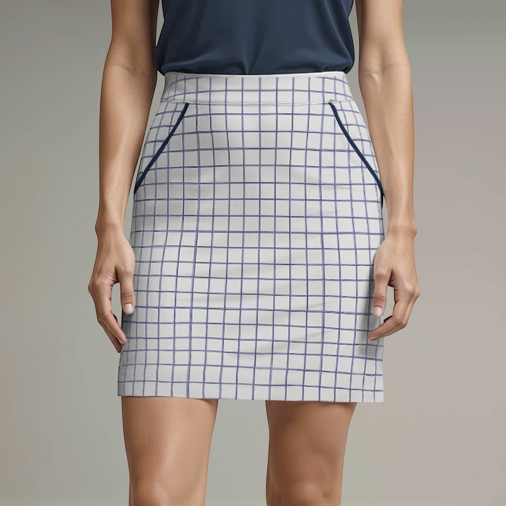 Elliott & Rose white windowpane golf skort with navy trim and elasticized waist. Features four pockets and a 17” length.