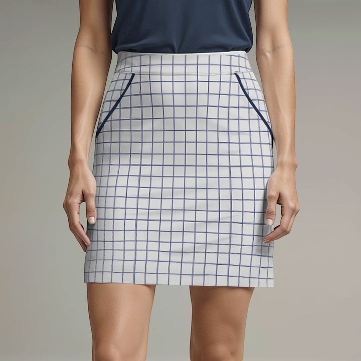 Elliott & Rose white windowpane golf skort with navy trim and elasticized waist. Features four pockets and a 17” length.